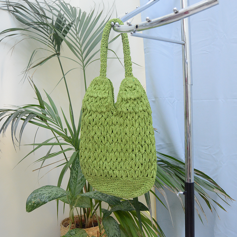 Handmade Raffia bag green color with magnetic button clasp.