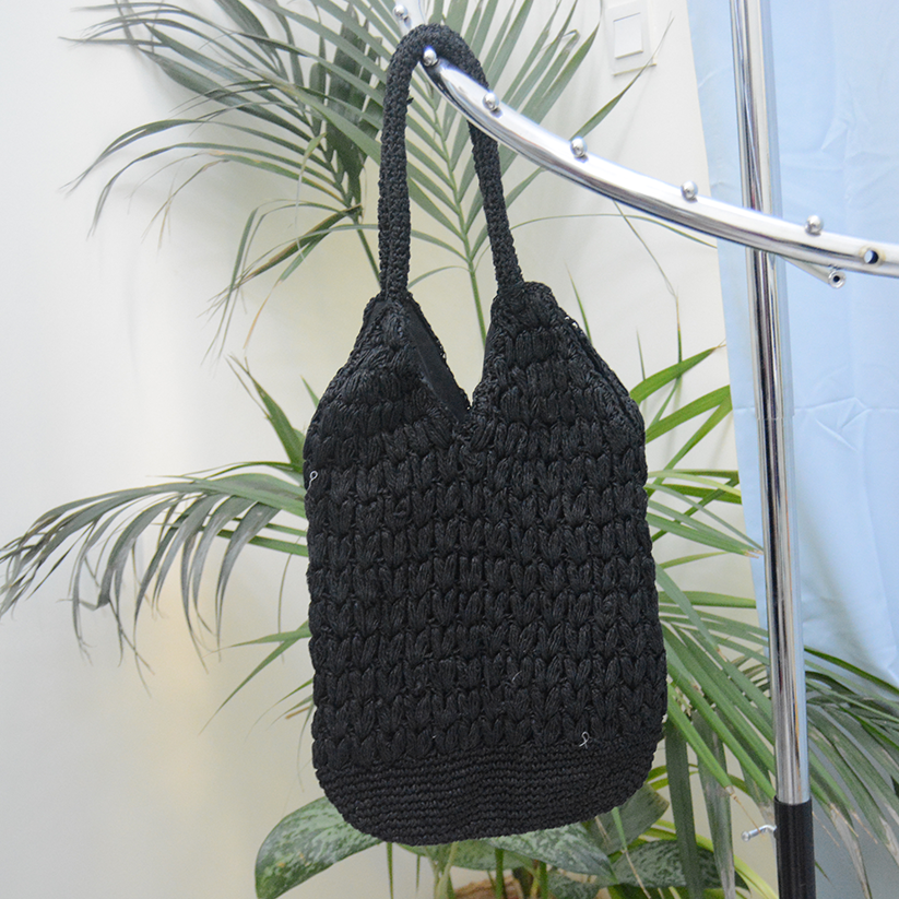 Handmade Raffia bag black color with magnetic button clasp.